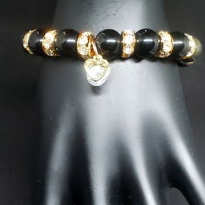 Black and gold bracelet with gold heart charm